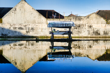 Water reflection of countryside houses next to paddy field, ready to replant