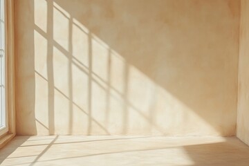 Sunlight casts shadows on a beige wall