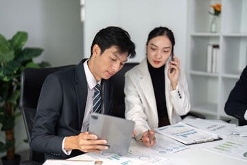 Business Meeting and Discussion. Two professionals analyzing market data and strategies in a modern office environment.