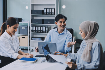 Diverse international executive business partners group discuss report at boardroom meeting table. Multiracial team negotiating project developing business strategy doing paperwork analysis in office.