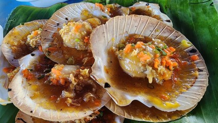 Grilled Scallops Served on Shells with Colorful Vegetables and Sauce