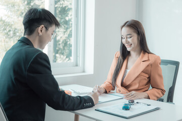 The customer checks the car loan agreement. insurance contract and other business documents required for purchasing vehicles, loans, businesses, electric cars.