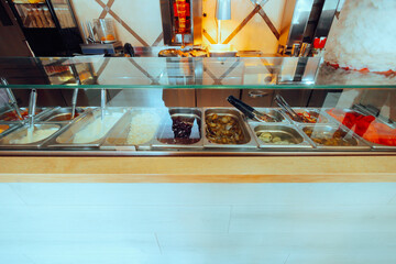 Fresh Food Display Case with Fresh Ingredients in Trays. Appealing fast food refrigerator...