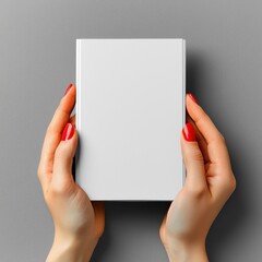 Two female hands holding a blank book with a soft gray background evoking a sense of calm and creative possibilities