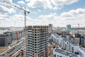 Fototapeta premium construction of new high-rise apartment building in urban residential area. aerial view with drone.