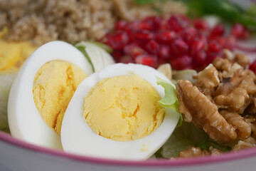 Delicious salad bowl featuring eggs, pomegranate, and walnuts