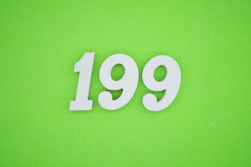 The numbers are made of white painted wood placed on a green paper background.
