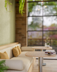 The books and a coffee cup on wooden table and fabric sofas in a cafe or a lounge with green wall.