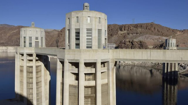 Intake towers stand tall at Hoover Dam, reflecting the impressive engineering against the backdrop of the arid Arizona landscape. Hoover Dam, Arizona, Nevada, USA