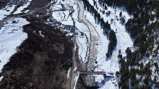 Aerial drone shot showcasing Chitkul&rsquo;s snow-covered landscapes, with deep valleys and pine forests adding to the surreal Himalayan beauty.