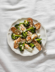 Alternative caesar salad with broccoli on a light background, top view