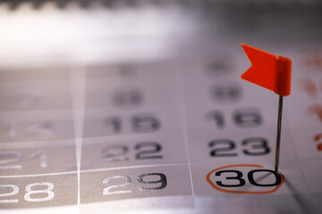 Red Flag on 30th Date of a Calendar Representing Deadlines, Appointments, or Important Events
