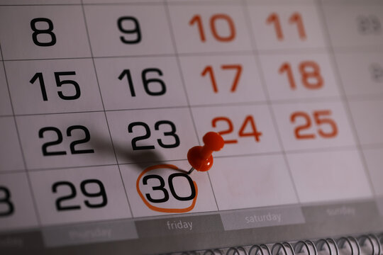 Close-up of Calendar Page with a Push Pin Marking the 30th Day