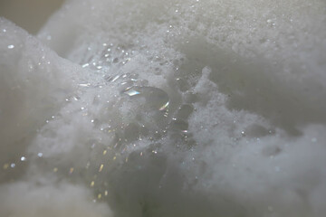 Close-Up of Sparkling Soap Foam with Shimmering Bubbles in Soft Light