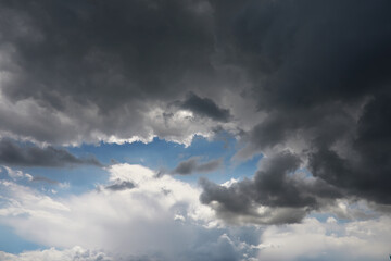 Dramatic Sky with Dark Storm Clouds and Bright Blue Patch in the Sky