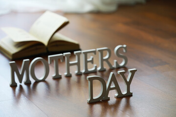 Mother's Day Celebration: Open Book and Letters Display on Wooden Floor