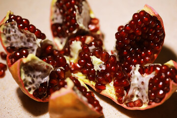 Fresh Opened Pomegranate with Juicy Seeds Displayed on Light Surface