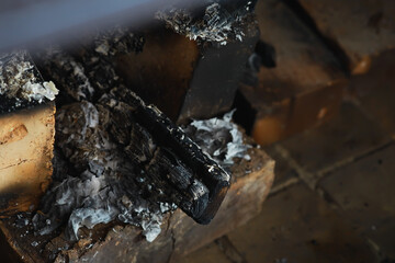 Close-up of Charred Wood and Ashes in Fireplace
