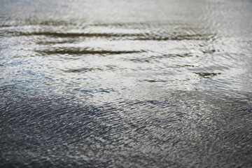Tranquil Water Surface Rippled by Wind Reflecting Sky and Light