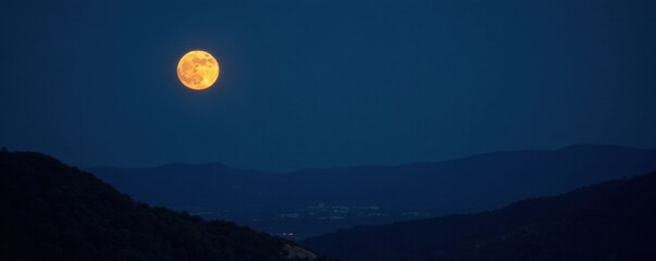 Waning gibbous moon rising over dark landscape, scenic view, dark
