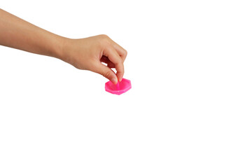 Boy's hand holding a spinning top on white background