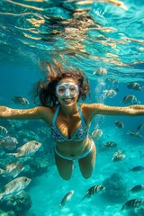 Fototapeta premium Exploring coral gardens. Exploring reef ecosystems. Beach tourism photography. Blue water snorkeling trip. Relaxation in nature. Seaside leisure and fun. Woman underwater with fish.