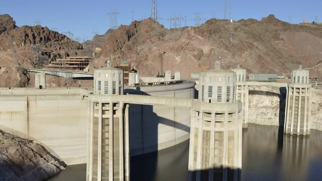 Intake towers stand tall at Hoover Dam, reflecting the impressive engineering against the backdrop of the arid Arizona landscape