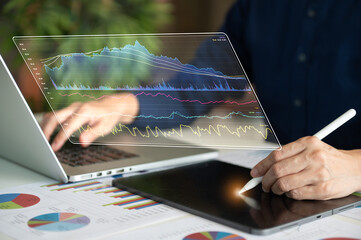 businessman using touchpad computer with financial report spreadsheet virtual screen interface for...