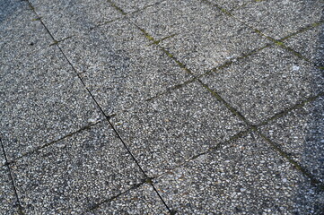 Granite paving stone texture with rectangular tiles. Rough stone surface background for architecture, design, and 3D rendering projects. Natural gray pavement pattern with visible joints.