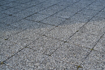 Granite paving stone texture with rectangular tiles. Rough stone surface background for architecture, design, and 3D rendering projects. Natural gray pavement pattern with visible joints.