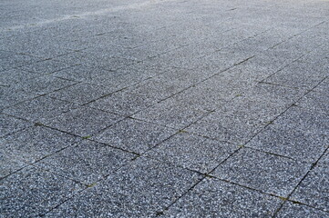 Granite paving stone texture with rectangular tiles. Rough stone surface background for architecture, design, and 3D rendering projects. Natural gray pavement pattern with visible joints.