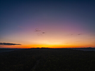 Aerial view A breathtaking sunset paints the sky with vibrant hues of orange and red, .casting a...