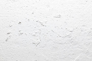 A white wall with a rough texture