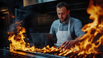 Chef Using Laptop Near Flames - Modern Restaurant Management Concept