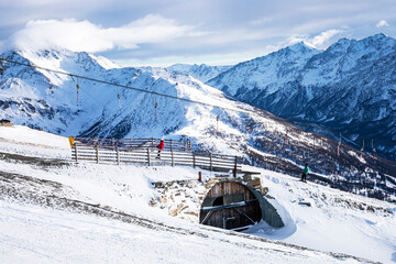 beautiful view of evening mountain peaks and ski lifts in the alps
