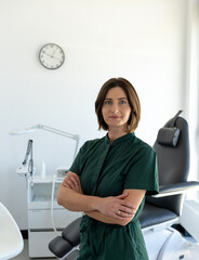 portrait of a woman cosmetologist in a medical uniform against the background of a medical chair....