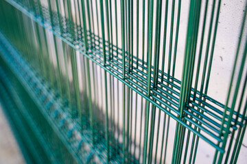 Welded mesh for fence in green color, several sections of transparent fence