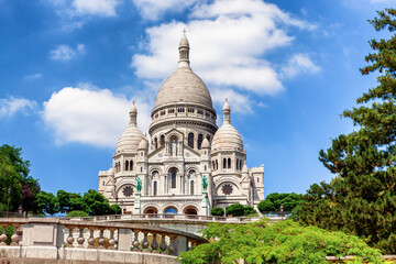 The Basilica of Sacré Cœur de Montmartre situated atop a hill with a stone balustrade