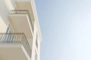Modern building exterior with balconies under clear sky during daytime