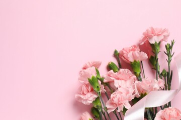 Beautiful bouquet of pink carnations on a colored background