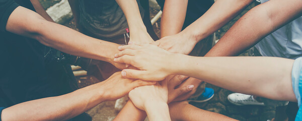 Banner diversity solidarity team multiethnic Partners hands together teamwork. Group of multiracial...