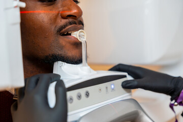 Dentist performing dental x ray scan on patient