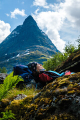 Female hiker resting in front of Inneralst&aring;rnet summit in Norway