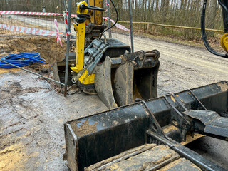Fenced excavations in the ground along the road during construction of the sewage system