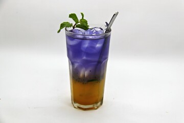 Refreshing Indonesian drink made with passion fruit and butterfly pea flower, Es Markisa Bunga Telang. Naturally vibrant with a sweet and tangy flavor, served cold with ice.