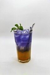 Refreshing Indonesian drink made with passion fruit and butterfly pea flower, Es Markisa Bunga Telang. Naturally vibrant with a sweet and tangy flavor, served cold with ice.