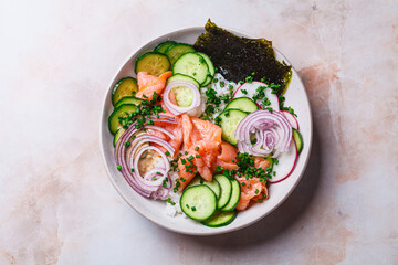 Salmon sushi salad with rice, vegetables and nori.