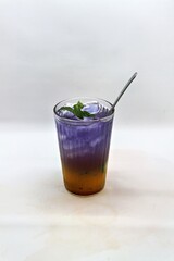 Refreshing Indonesian drink made with passion fruit and butterfly pea flower, Es Markisa Bunga Telang. Naturally vibrant with a sweet and tangy flavor, served cold with ice.