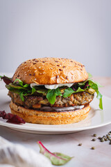 Vegan  lentil burger with pesto and vegan cream cheese.