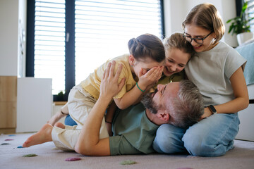 Portrait of father with three daughters at home.